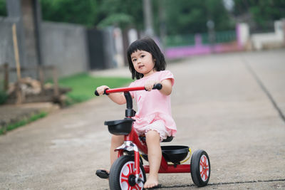 Full length of cute girl riding motorcycle