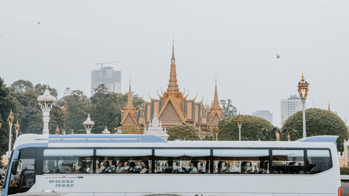 Panoramic view of buildings and trees against sky in city