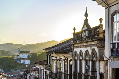 Colonial style houses facade and historic baroque church on the hills of ouro preto