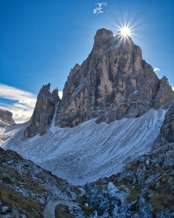 Scenic view of mountain against blue sky on sunny day