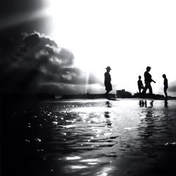 Silhouette people in swimming pool