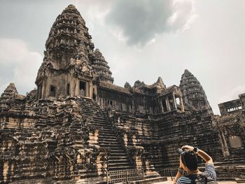 Panoramic view of temple and building against sky