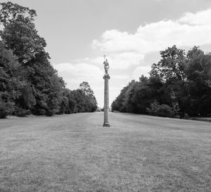 View of tower in park against cloudy sky