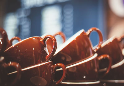 Stack of brown coffee cups in restaurant