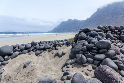 Rocks on beach against sky