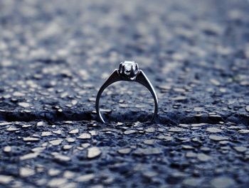 Close-up of wedding ring on road