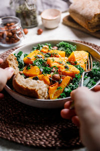 Close-up of hand reaching to food