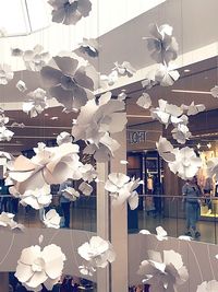Low angle view of illuminated decorations hanging on ceiling in building