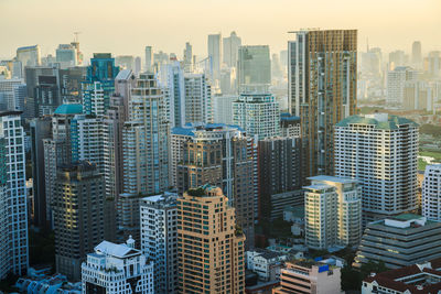 View of buildings in city against sky during sunset