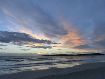 Scenic view of beach against sky during sunset