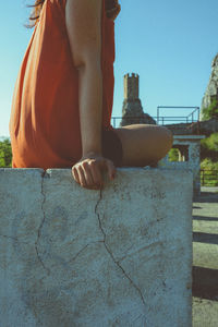 Close-up of hands against sky