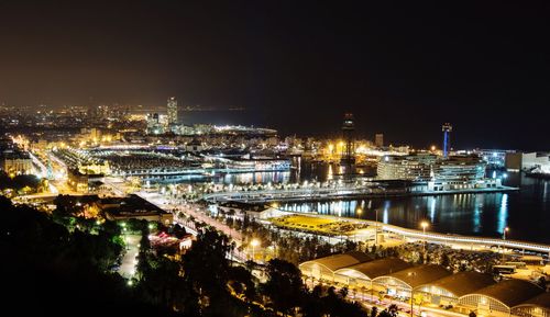 High angle view of illuminated cityscape against sky at night