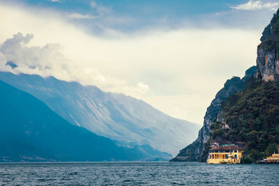 Scenic view of sea and mountains against sky