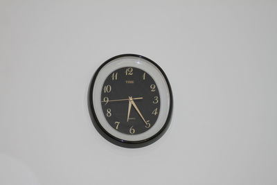 Close-up of clock on wall