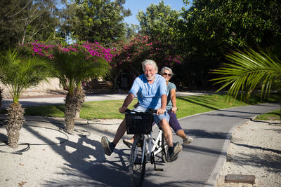 Portrait of a smiling woman riding bicycle