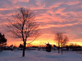 Scenic view of snow covered landscape at sunset