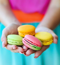 Close-up of hand holding multi colored candies