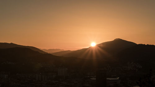 Scenic view of sunset over mountains