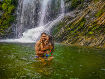 Full length of a smiling young woman in water