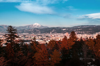 Aizu wakamatsu city  scenery with snow mountain in winter with evening light.