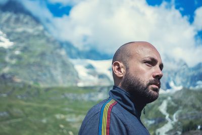 Close-up of man standing against mountains