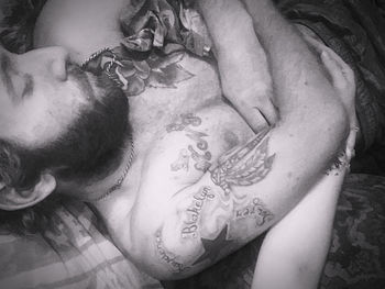 Close-up portrait of woman relaxing on bed