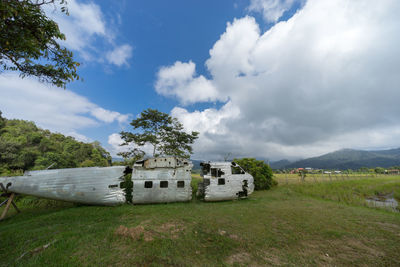 Built structure by trees against sky