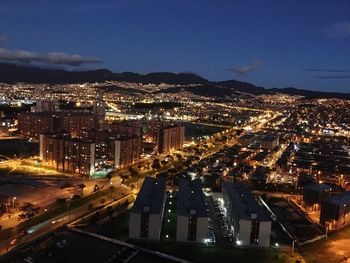 Illuminated cityscape against sky at night