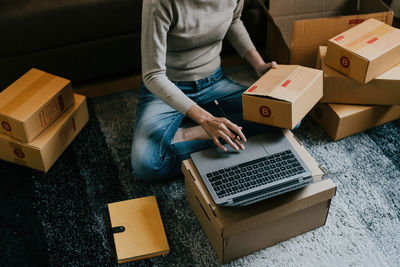 Midsection of man using laptop on table