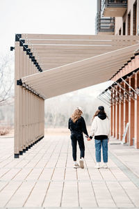 Low angle view of woman standing against building