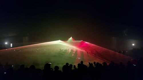 People enjoying music concert at night