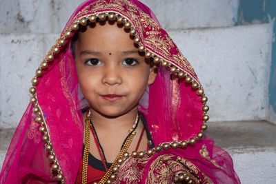 Girl kid cute facial expression in marriage ceremony dress from unique low angle shot in details