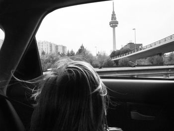 Portrait of woman in city against clear sky