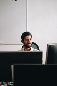 Close-up of smiling businessman working in office