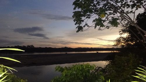 Scenic view of lake against cloudy sky