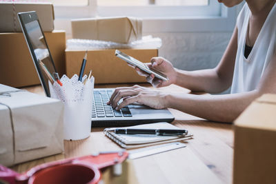 Midsection of woman working on table