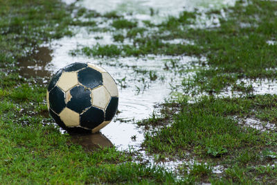 Soccer ball on field by lake