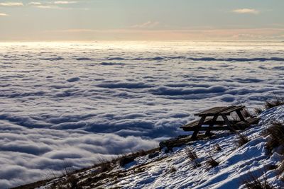 Picnic table on snow covered landscape