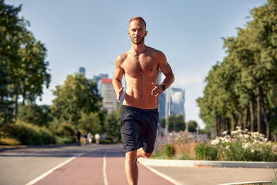 Full length of man exercising on road