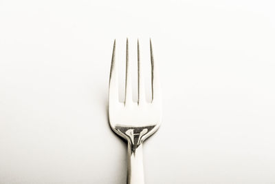 Close-up of fork over white background