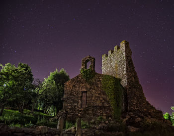 Old temple against sky at night