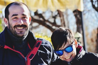 Portrait of smiling couple standing outdoors