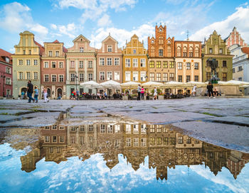 Group of people in front of buildings against sky