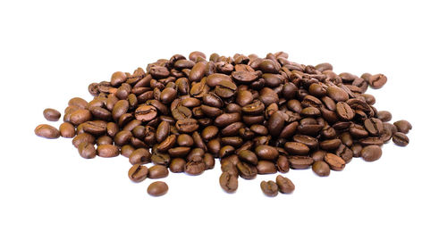 High angle view of coffee beans against white background