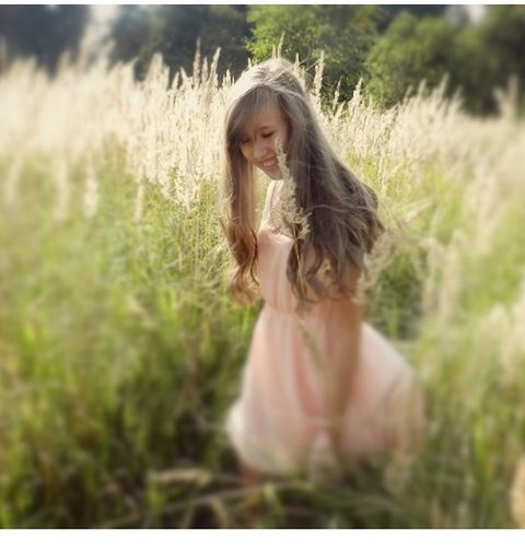 long hair, young adult, person, young women, lifestyles, grass, leisure activity, casual clothing, field, portrait, standing, looking at camera, three quarter length, tree, nature, plant, brown hair