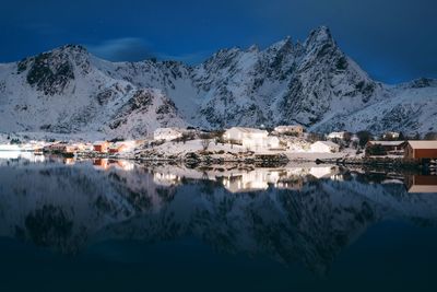 Scenic view of snowcapped mountains by lake during winter