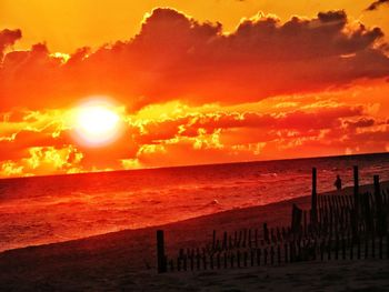 Scenic view of sea against orange sky