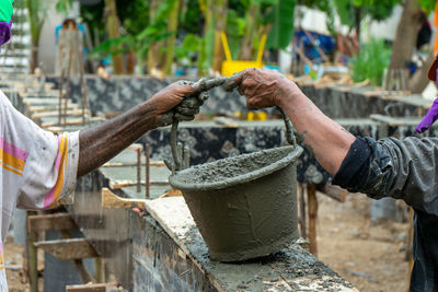 Close-up of man working on wall