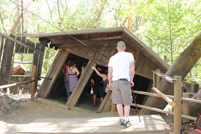 Rear view of man standing by built structure