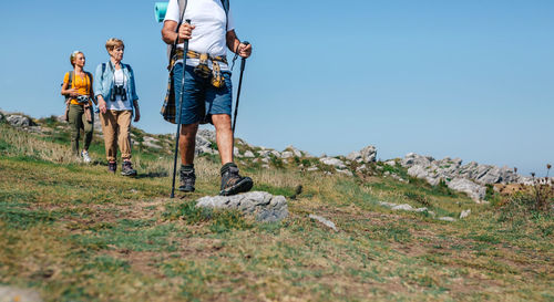 People on land against clear sky